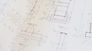 Close-up of a detailed architectural blueprint showcasing design and planning.
